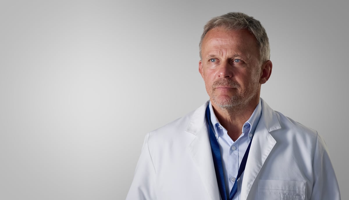 Mature Male Doctor Wearing White Lab Coat